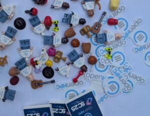 Close-up of OpenHPC-branded Lego minifigures and stickers being given away at the booth